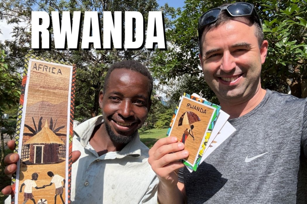 American expat visits Kigali Rwanda and takes a selfie with an artist vendor in a clean park.
